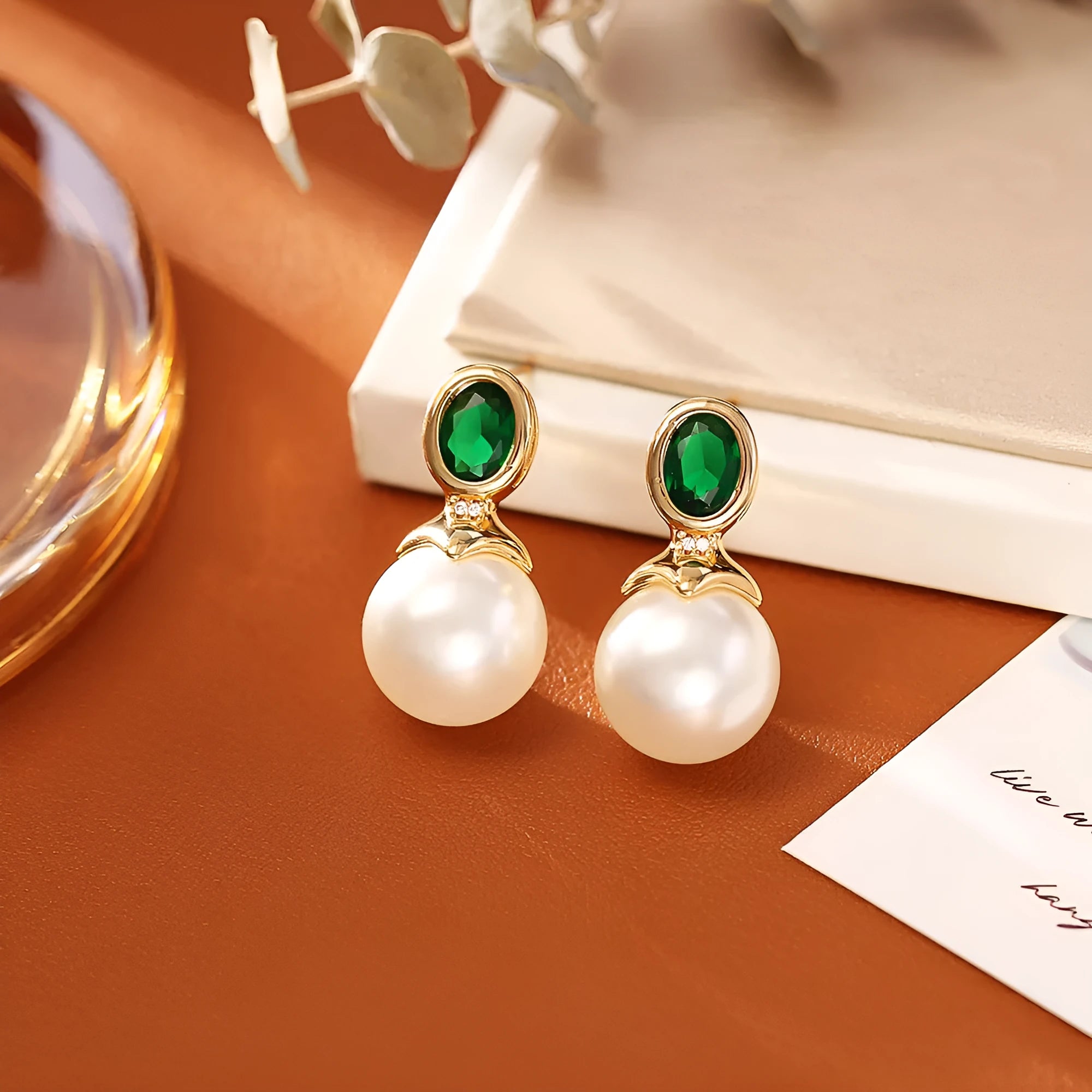 High-grade ruby pearl stud earrings with real gold plating on copper, round geometric shape, available in red or green