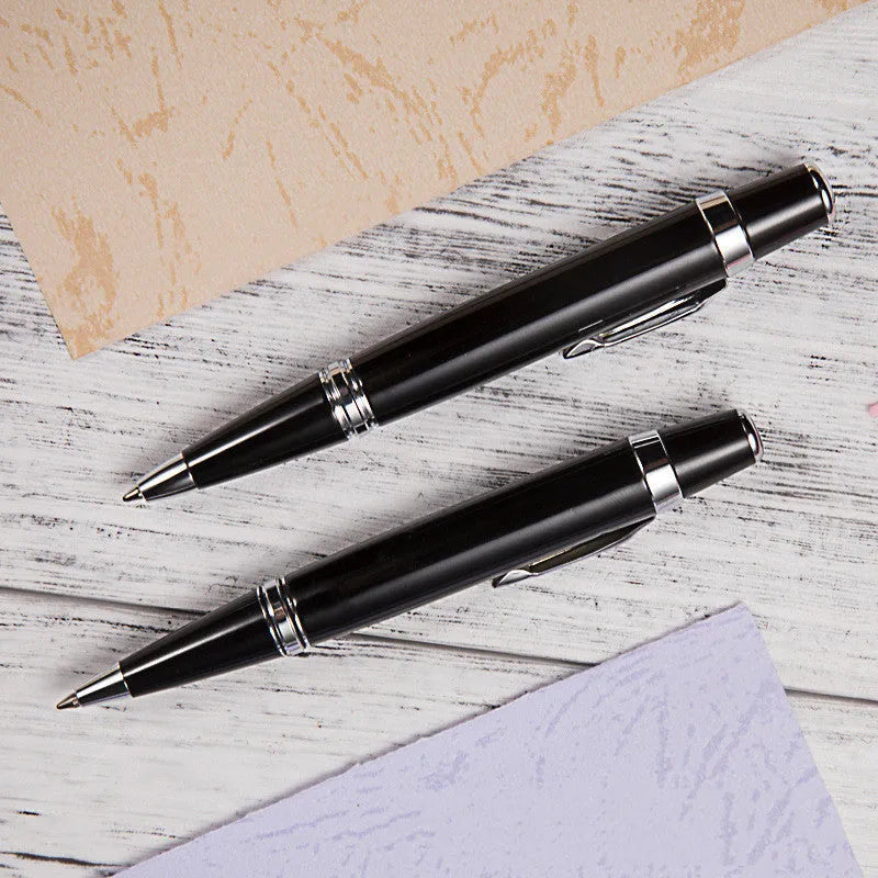 Short black metal ballpoint pen with rotating mechanism, showing bullet tip and compact dimensions