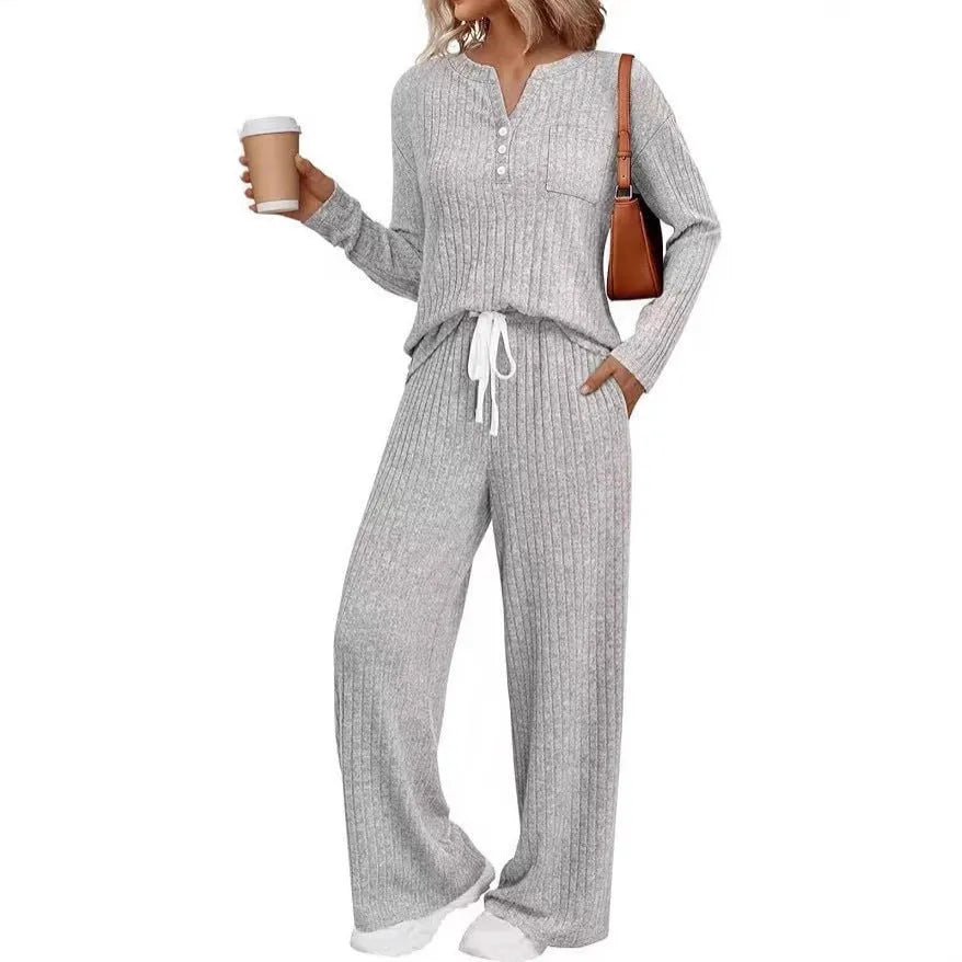Women's light grey striped knitted long coat with v-neck, long sleeves, and lace-up detail on a mannequin.