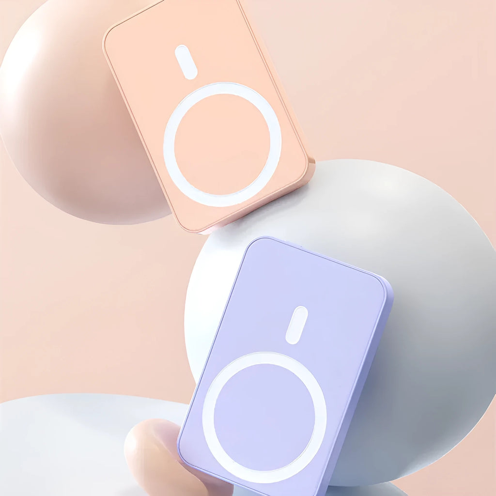 Pink magnetic wireless power bank showing 20000mAh capacity and 20W output on a table.