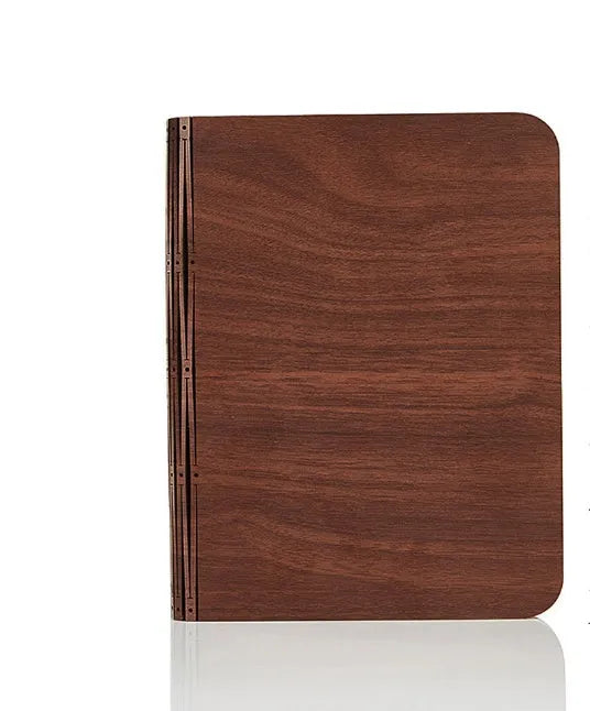 Solid wood USB book light in three sizes on a wooden table.