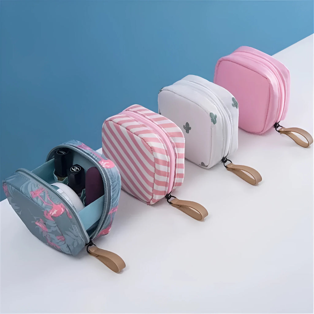 A blue cloth cube-shaped makeup storage bag with a plain pattern, sitting on a surface.