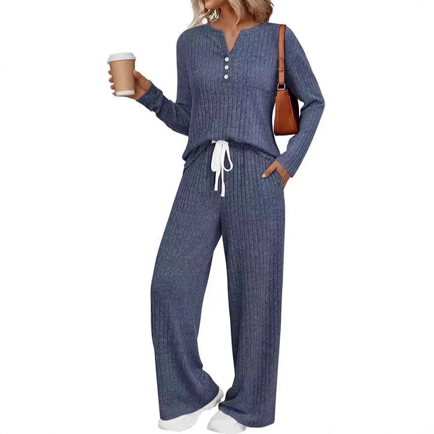 Women's light grey striped knitted long coat with v-neck, long sleeves, and lace-up detail on a mannequin.