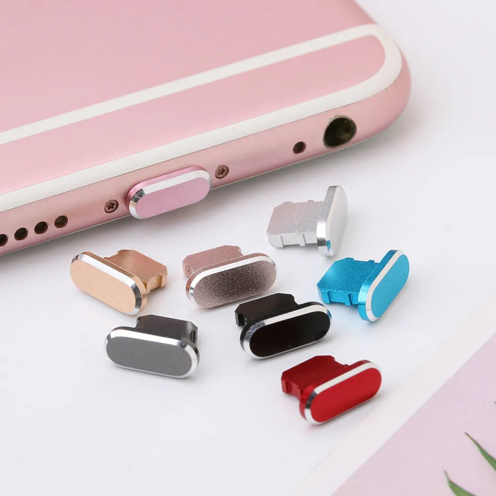 Aluminium alloy iPhone charging port dust plug shown in gold, silver, and rose gold colours.