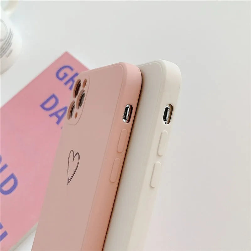 Silicone phone case for Apple iPhone in multiple solid colour options including black, pink, and purple