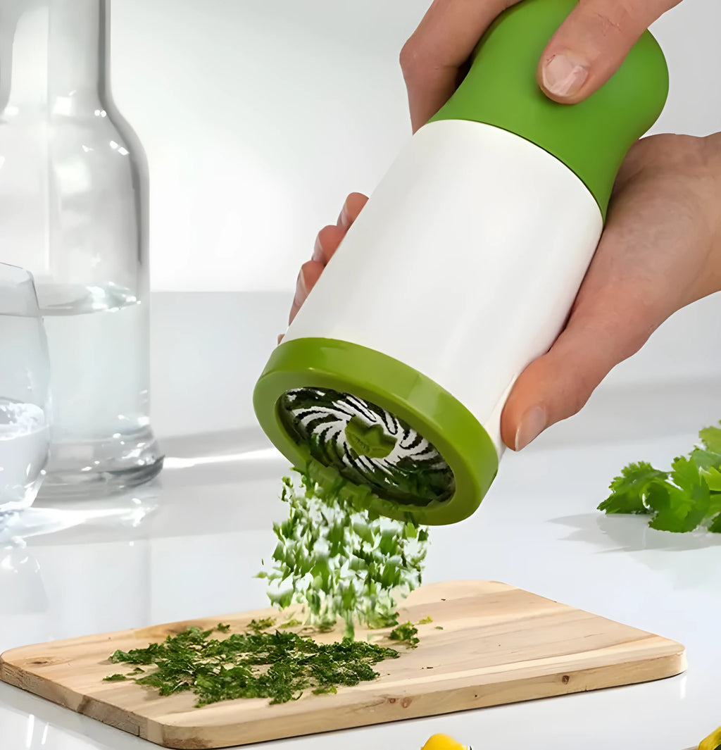 Manual PP plastic herb grinder with stainless steel blades and a removable top, shown upright.
