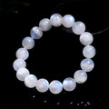 Natural blue moonlight polished moonstone round bead bracelet on wrist.