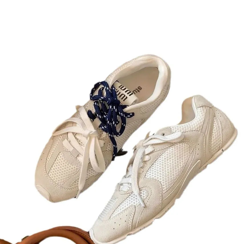 Women's retro German training shoes in milky white with flat heel and front lace-up design.