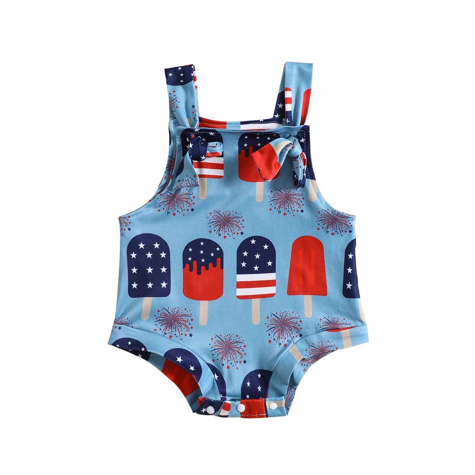 Baby girl wearing a sleeveless knotted front suspender pants jumpsuit in a printed design.