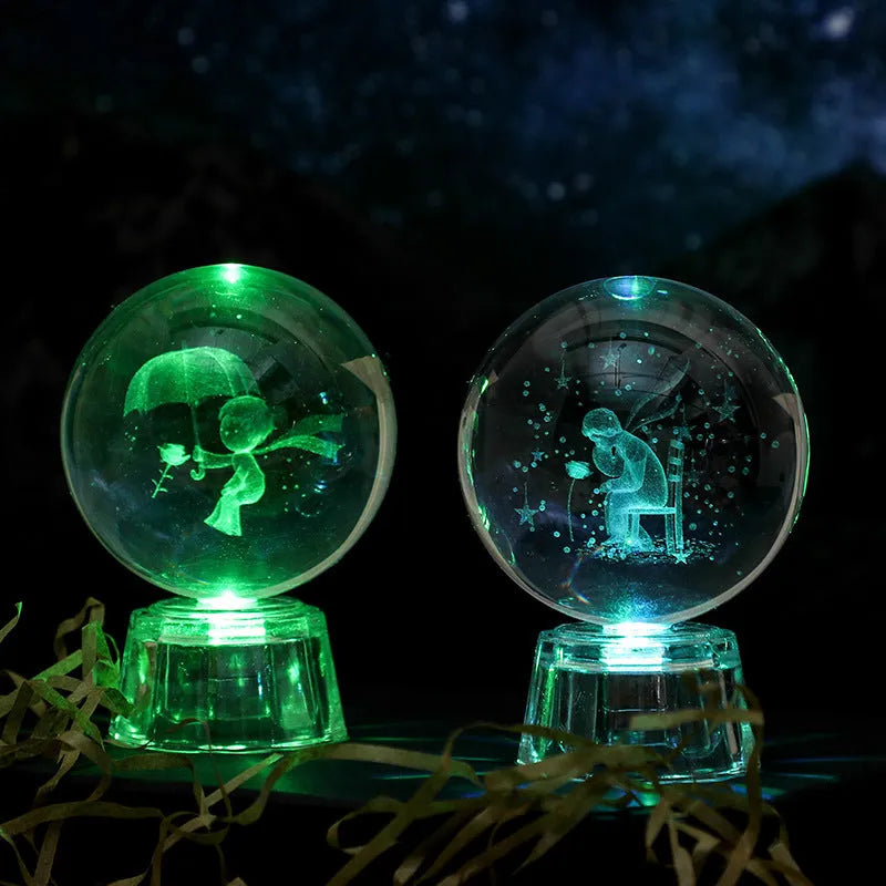 Transparent white luminous crystal ball ornament with inner carving on a fixed base for tabletop decor.