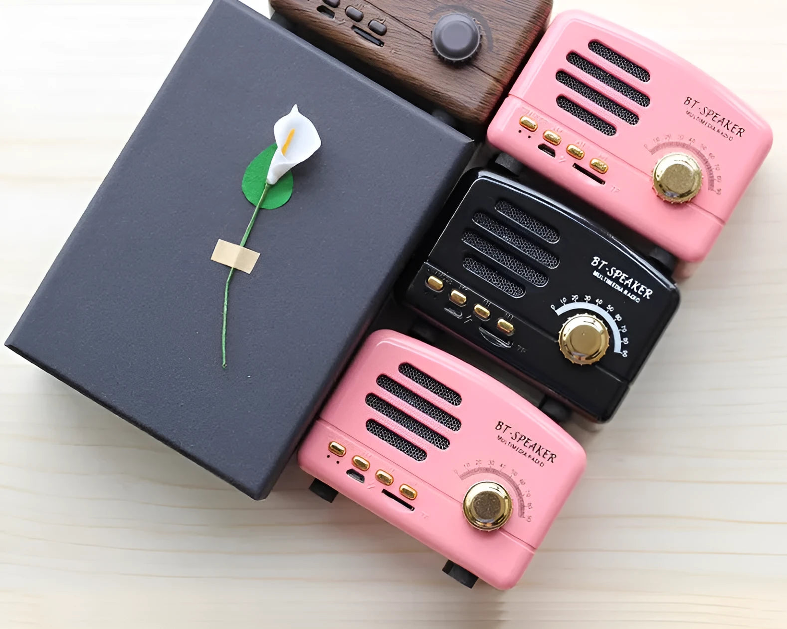 Compact portable Bluetooth speaker with a vintage wood grain finish on a plastic shell