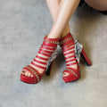 Women's black snakeskin high-top shoes with a fish mouth opening and thick block heel.