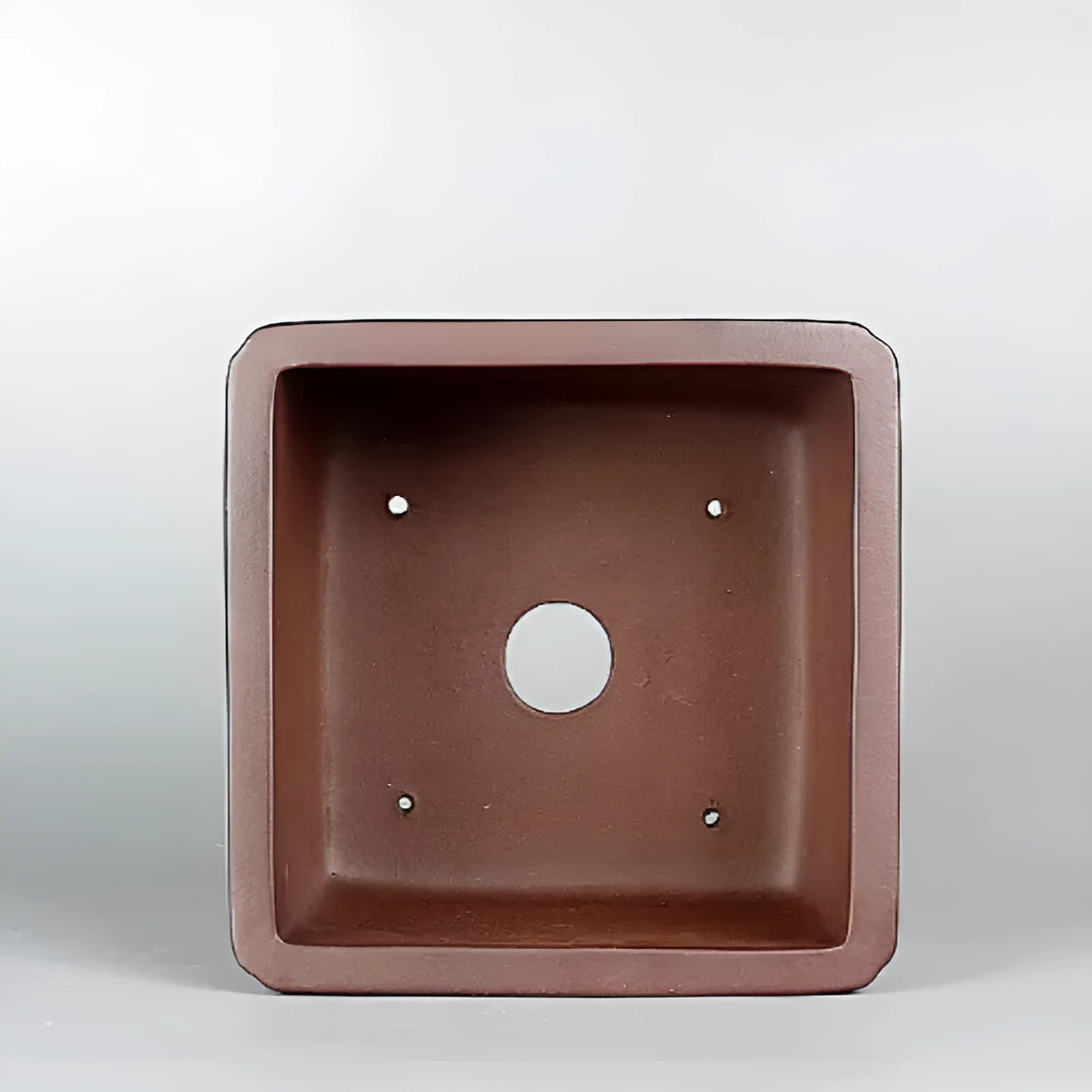 Handmade brown antique purple clay classical flower pot with a drainage hole.
