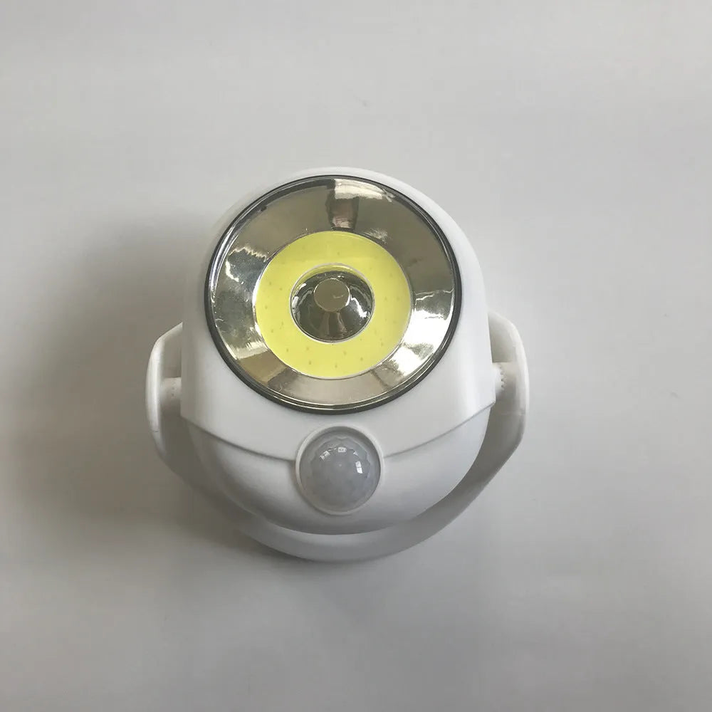 White Atomic Angel induction lamp with ABS plastic construction and 13.3cm dimensions