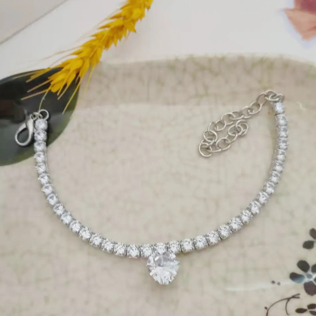 Gold rhinestone heart-shaped decorative collar for cat or dog on a white background.