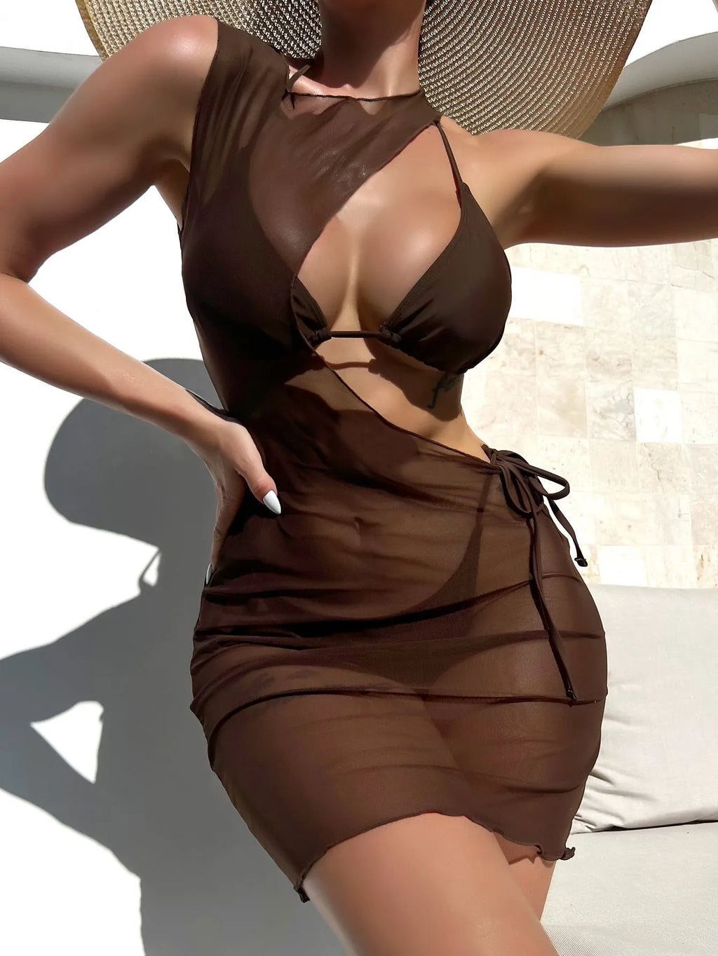 Brown women's three-piece swimsuit bikini set with bra, shorts, and blouse on mannequin