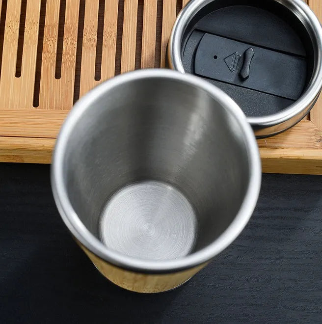 Bamboo travel coffee cup with thermal insulation, leak-proof lid, and 420ml capacity on foam pad