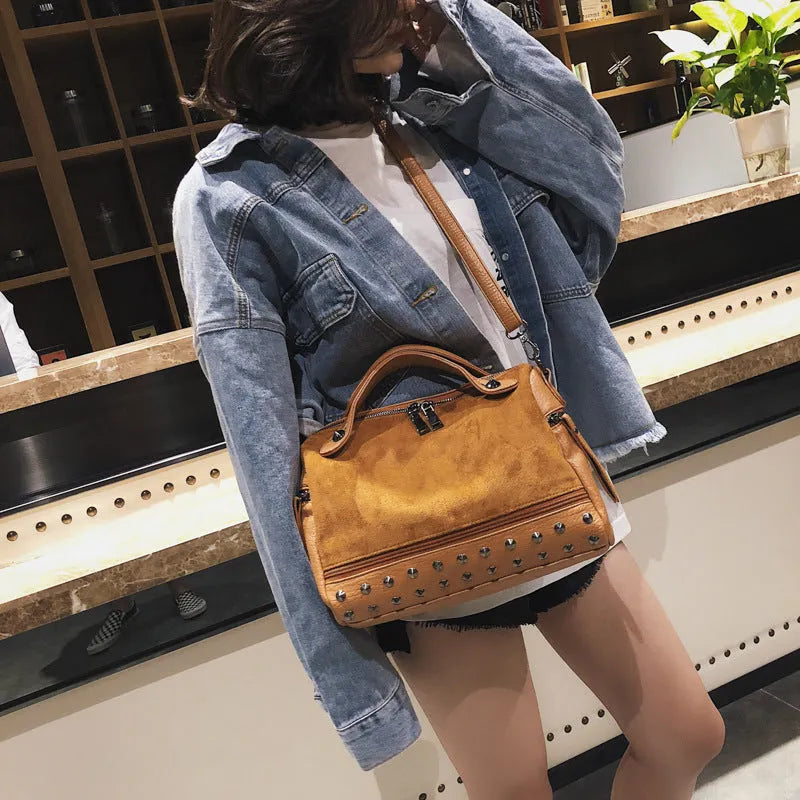 Soft grey PU leather women's tote shoulder bag with zip top on a table