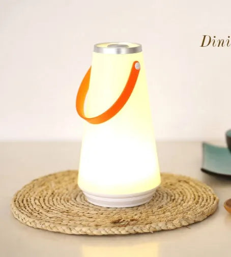 White USB rechargeable LED bedside night light with touch control on a wooden table.