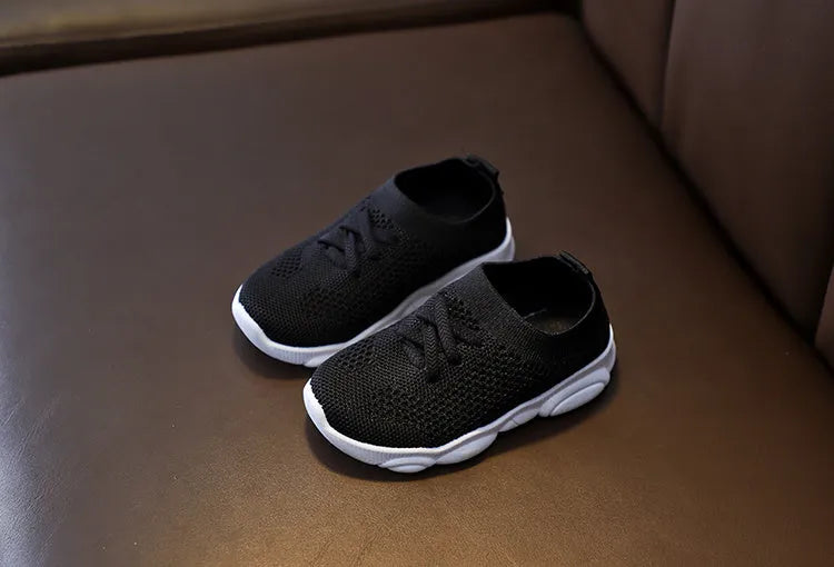 Children's fabric lazy shoes in white, black, pink, and grey colours with non-slip rubber sole
