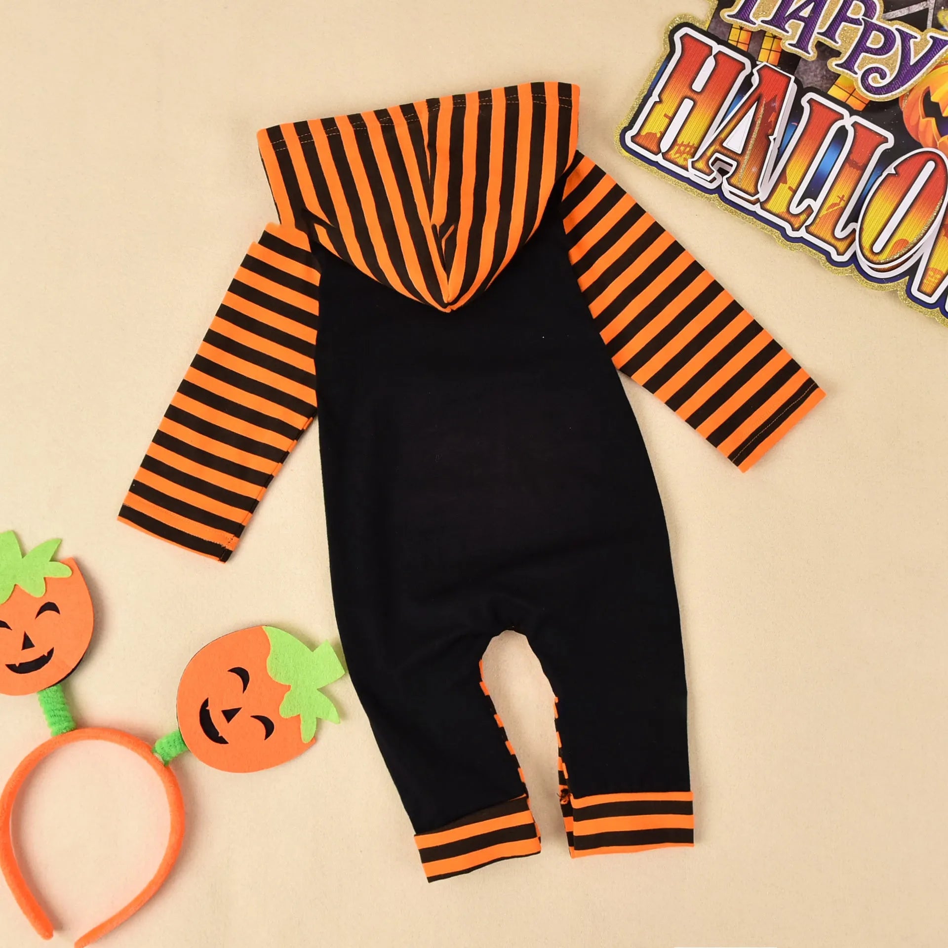 Black hooded long sleeve cotton Halloween romper for a child on a hanger.