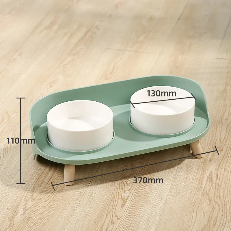 Green tilted pet feeding bowl with double compartments for food and water