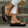 Pair of thick-soled herringbone-patterned flip-flops in blue, showing round toe and rubber sole.