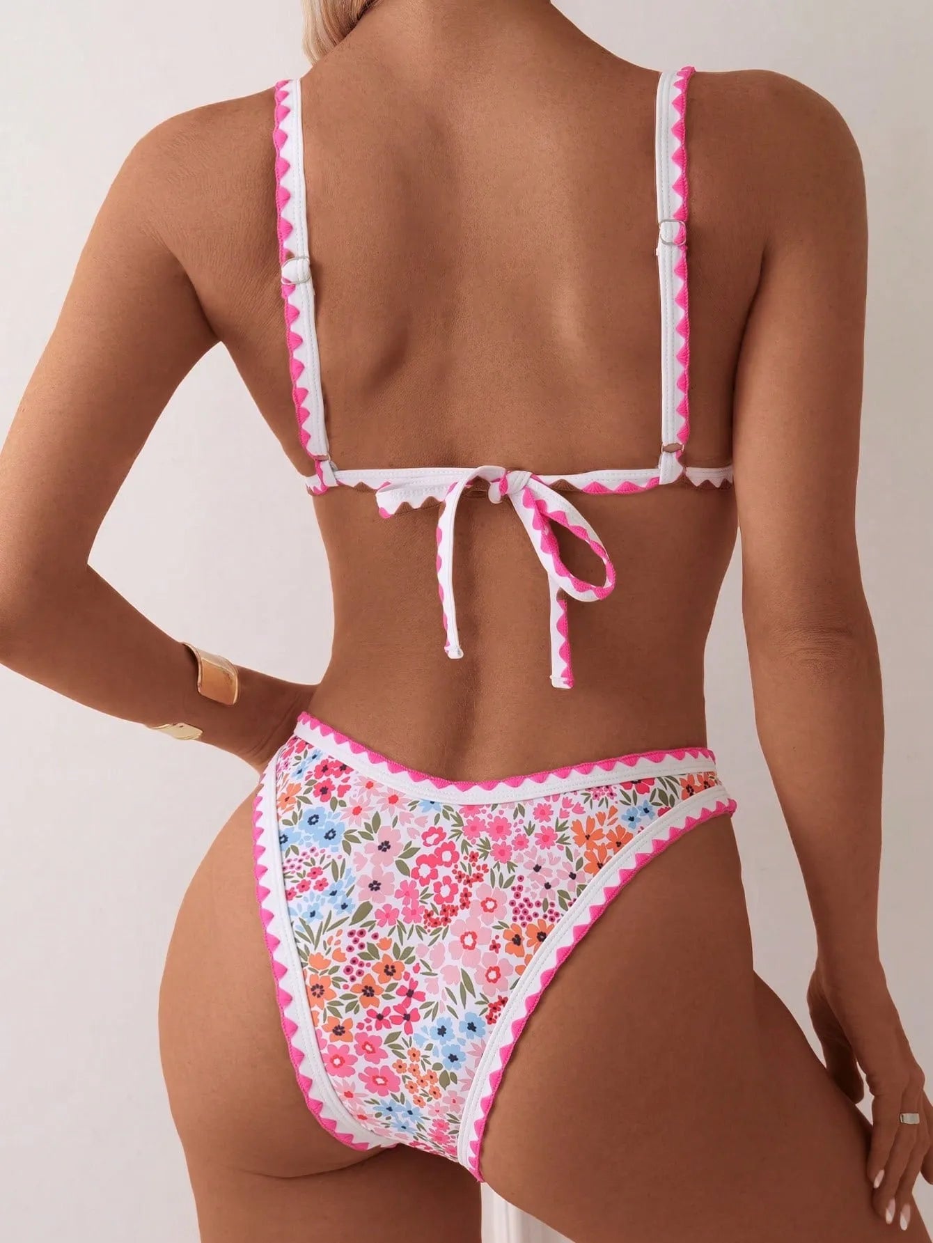 Women's printed lace-up bikini swimsuit with split briefs on a mannequin.