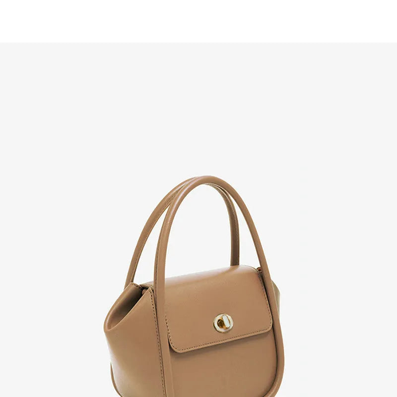 A wing-shaped cow leather women's tote bag with a cross-body strap and latch closure in a choice of colours.