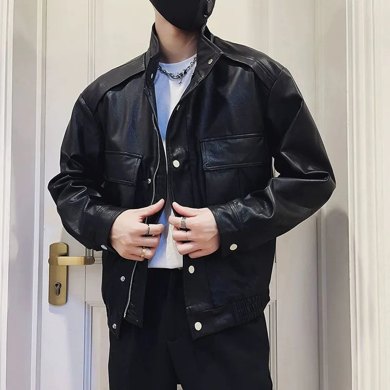 Man wearing a black PU leather pilot-style jacket with side pockets and a straight hem.