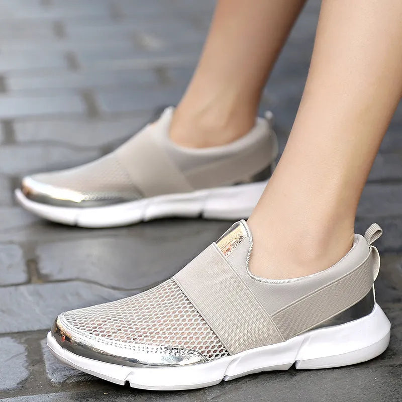Blue, black, and grey women's low-top sneakers with mesh interior and casual design.