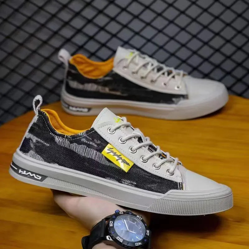 A pair of men's casual canvas lace-up shoes with a round toe and rubber sole.