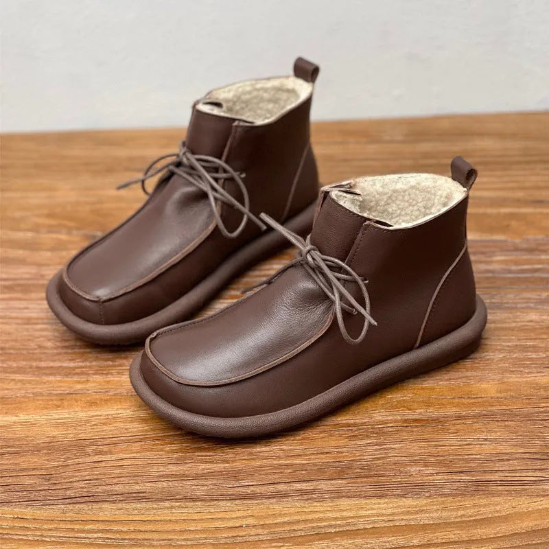 Women's casual cowhide boots with velvet lining in black and coffee colours showing round toe and flat heel design
