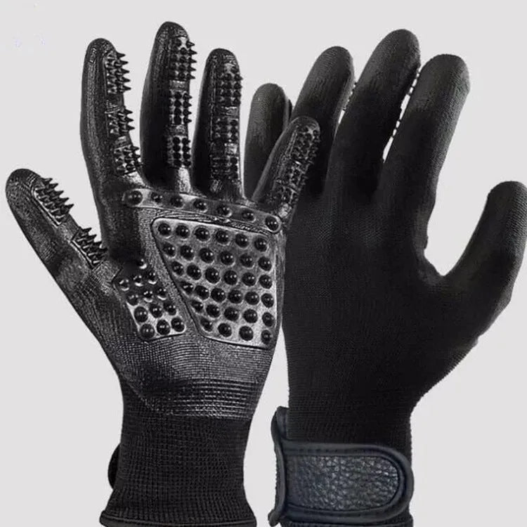 Pet hair grooming glove in black rubber with adjustable wrist strap on a light background