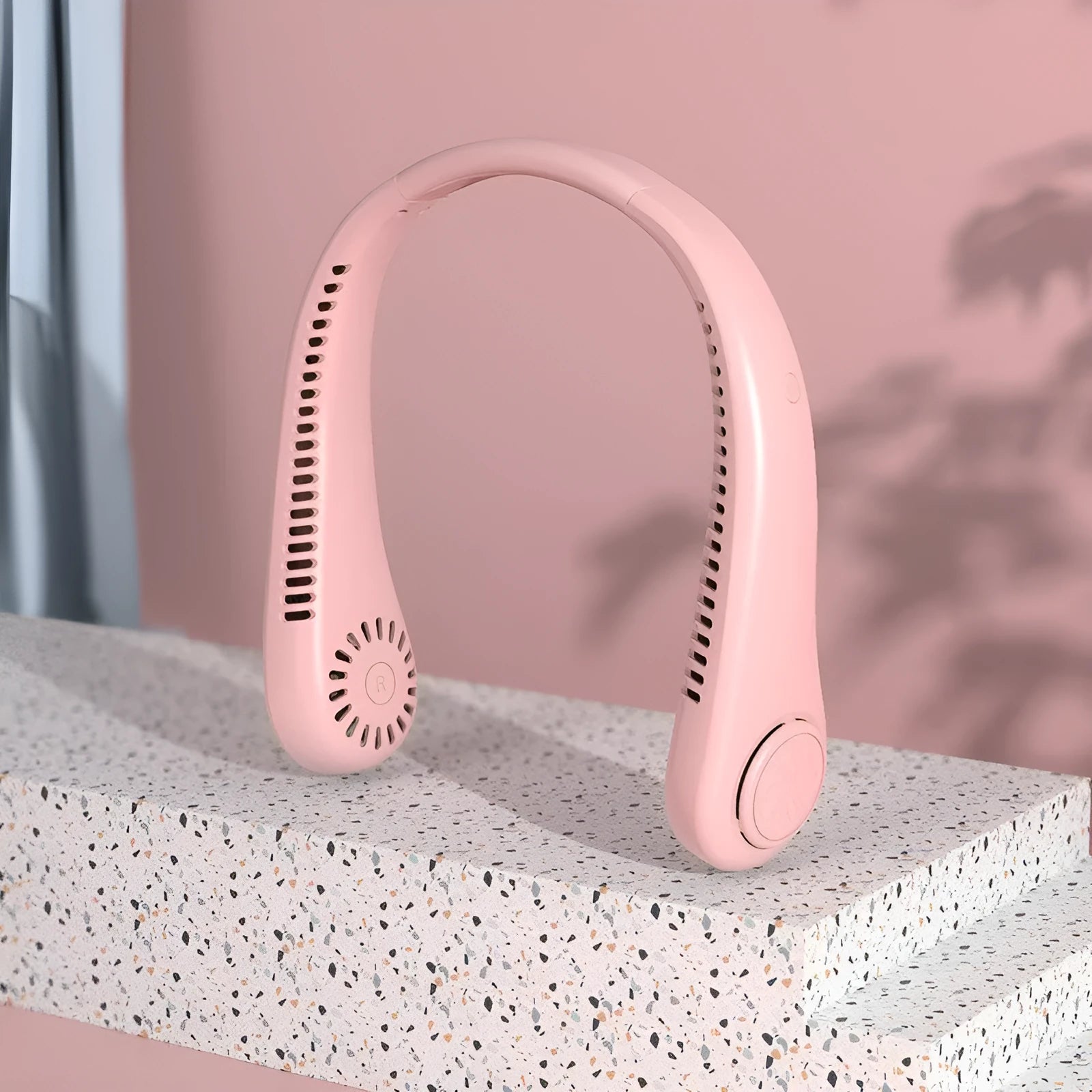 Pink USB rechargeable bladeless neck fan with flexible neckband.