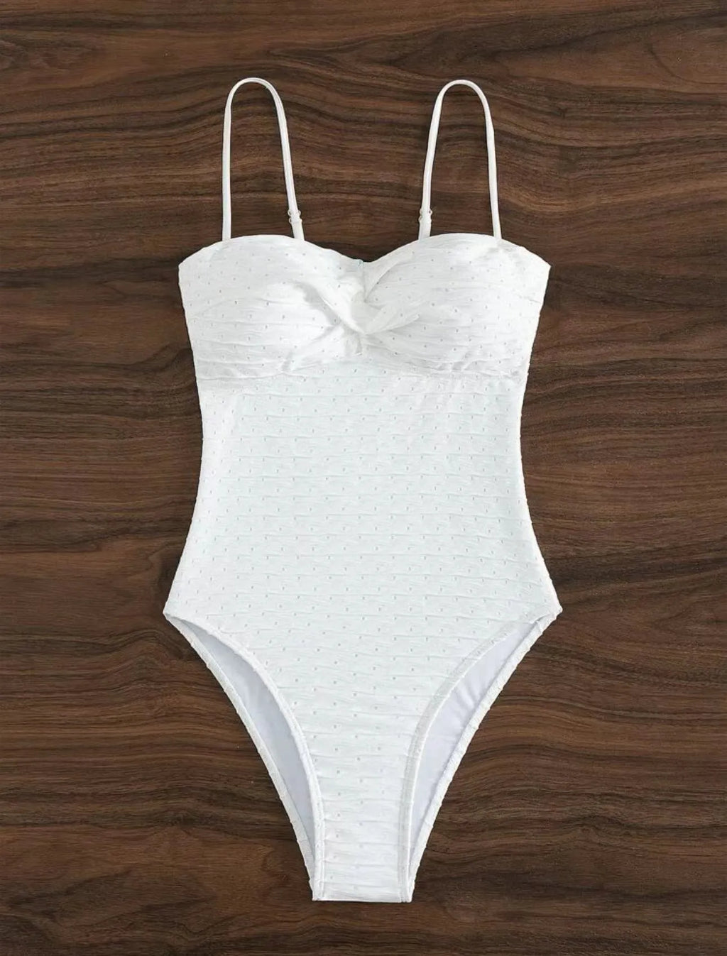 White one-piece sling-back swimsuit for women on a mannequin, showing briefs style.