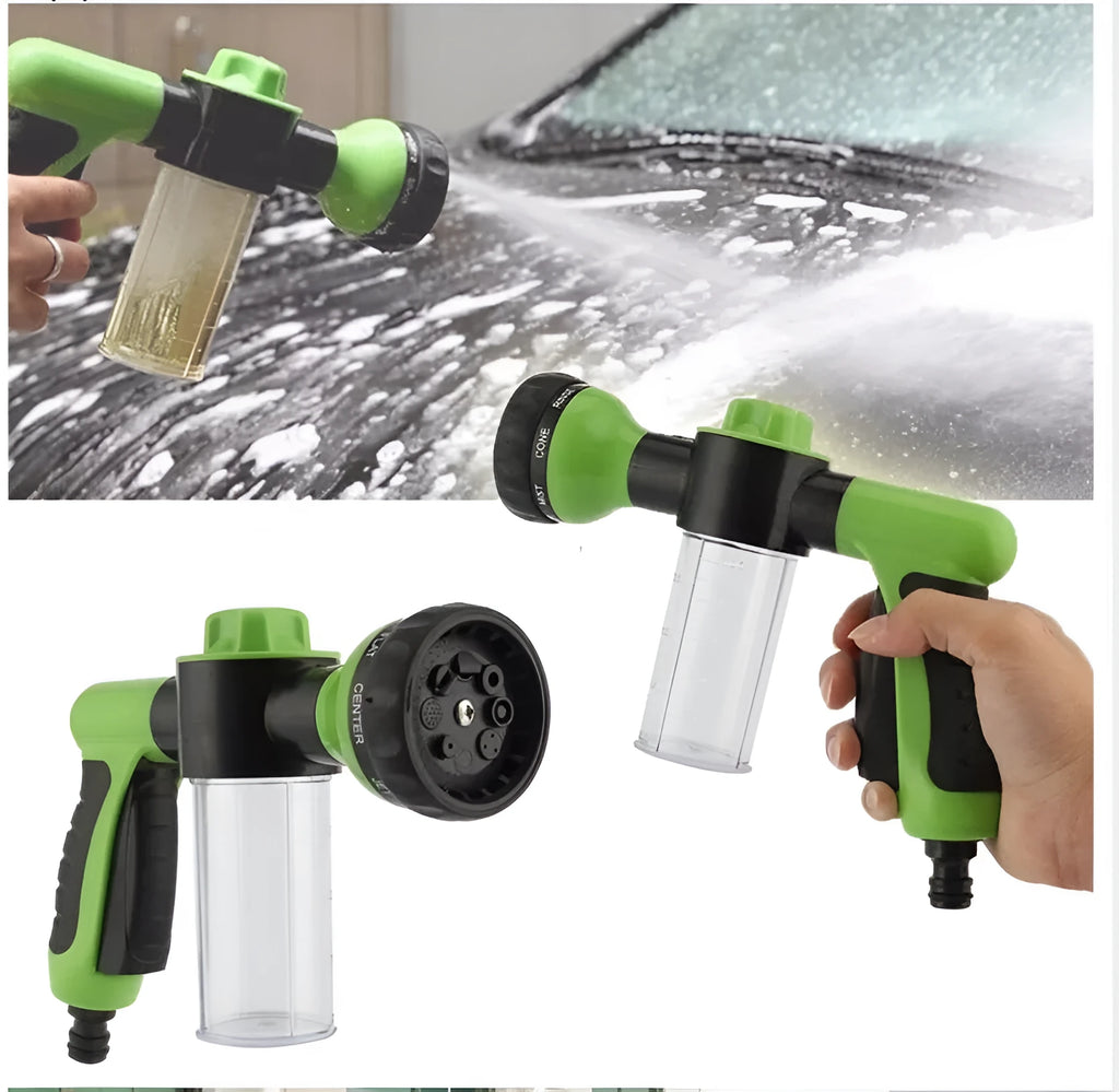 Green high-pressure foam spray gun with adjustable nozzle and connected water hose for car and garden cleaning.