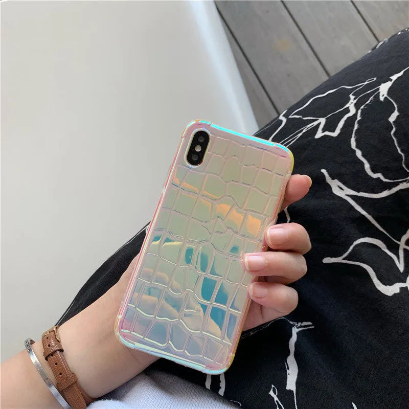 Silver glossy laser design silicone case for iPhone on a table.