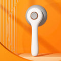 Blue and white self-cleaning pet grooming brush with massage function for cats and dogs.