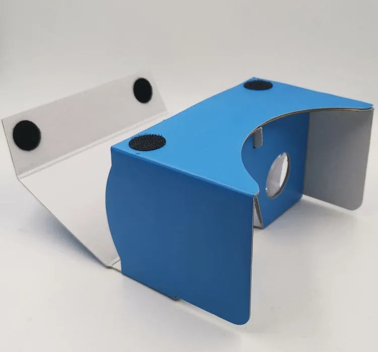 Pink and white cardboard VR glasses for smartphones with 3D lenses and a rubber strap.
