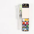Fan-shaped foldable solid watercolour paint set in transparent plastic box with fountain pen and sponge.