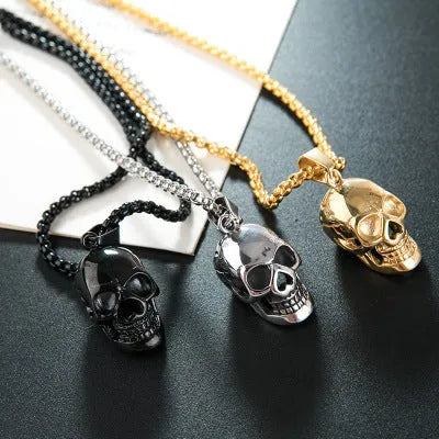 Halloween skull necklace in alloy and stainless steel with gold colour option on a black background