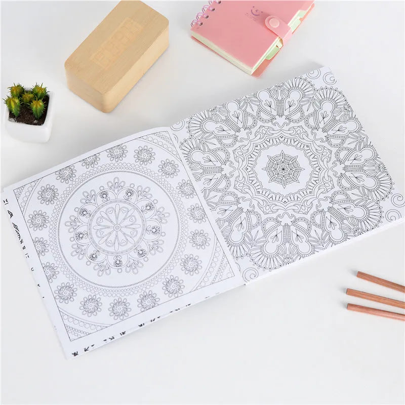A5 mandala colouring book open showing black ink patterns on white paper with soft binder cover