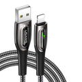 Black braided lightning data cable with zinc alloy connector next to an iPhone 12.