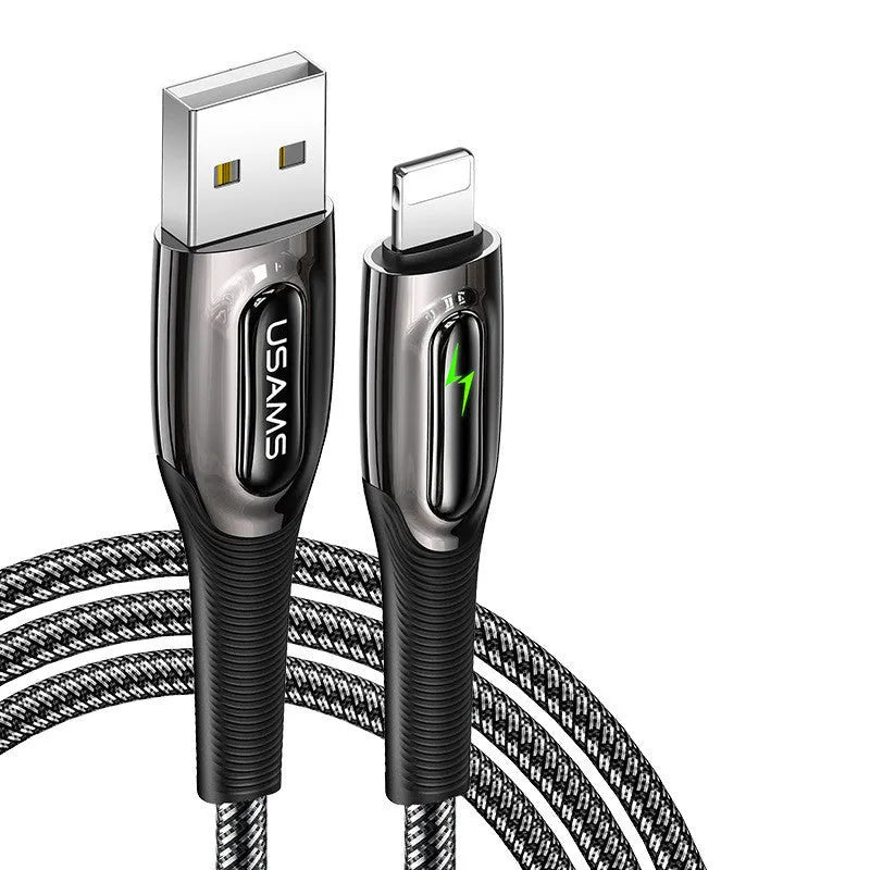 Black braided lightning data cable with zinc alloy connector next to an iPhone 12.