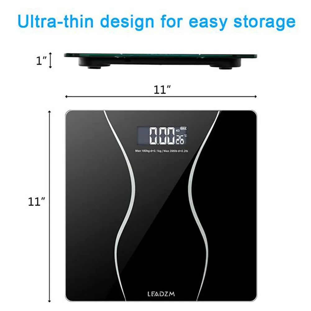 Black electronic digital body scale on a floor with a 180kg maximum capacity.