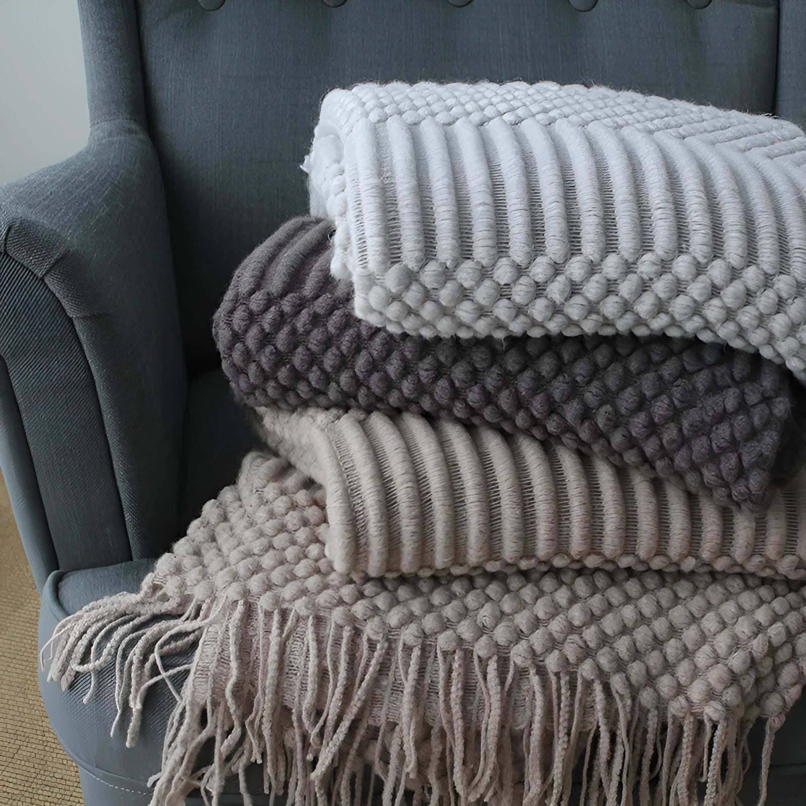 Polyester fibre small throw blanket in dark grey, khaki, or light grey, showing its 127x170cm size.
