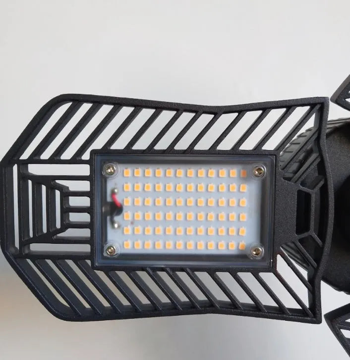 Waterproof industrial foldable garage lamp with die-cast aluminium housing and a clear polycarbonate lens.
