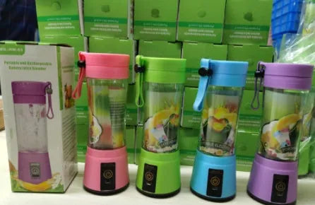 Pink portable USB blender with six blades and a 380ml transparent cup on a table