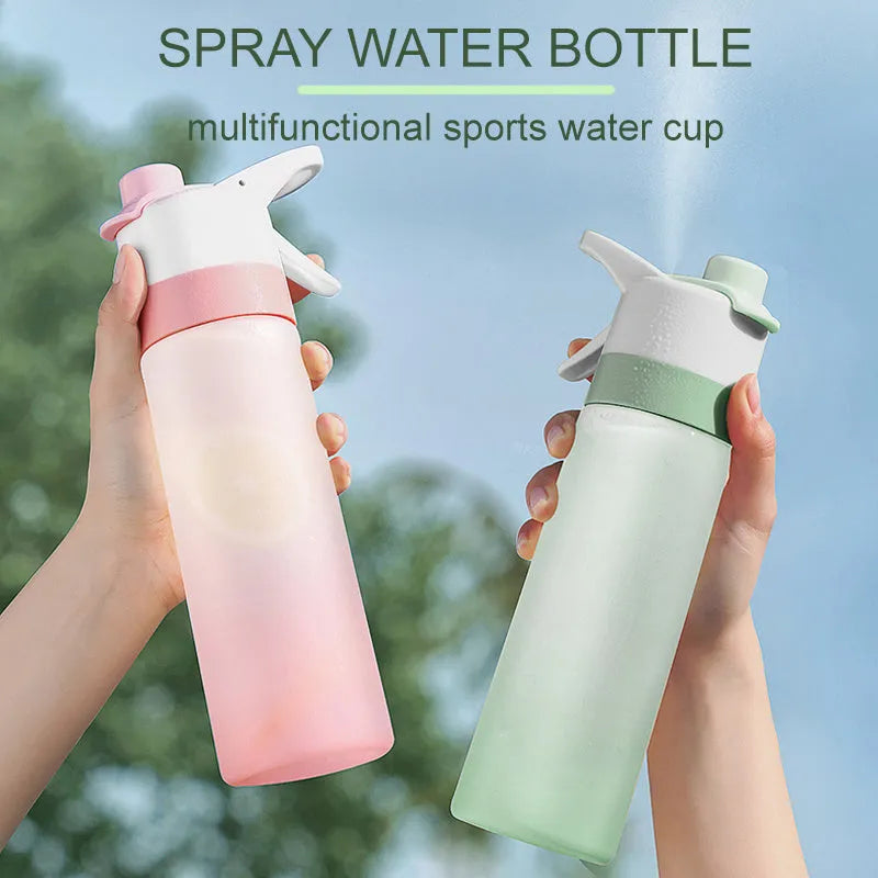 White 700ml plastic spray water bottle with a black handle strap and leakproof lid on a table.